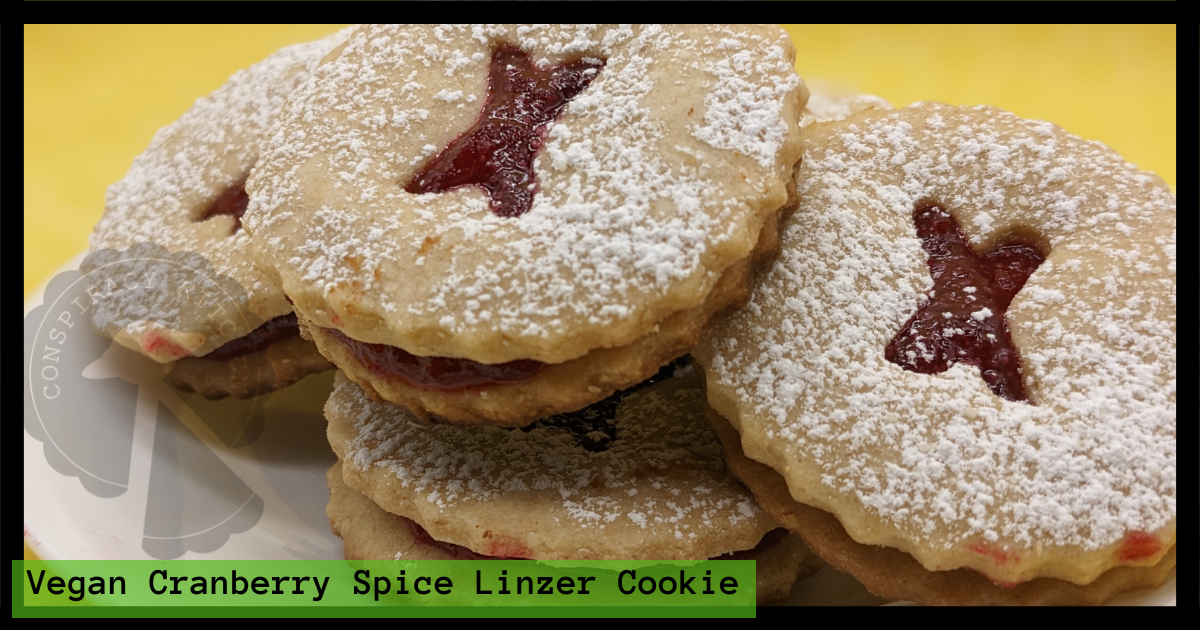 Image detailing the vegan cranberry Linzer cookies with an X-shaped cutout.